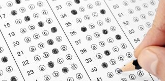 Photo of student filling bubble on test answer sheet.