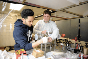 Associate Professor Matt Wright, PhD, works with a student in Adelphi University’s physics lab.