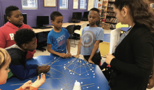 T.E.E.M.S. AmeriCorps Program member Aracely Navarro teaches her students about design thinking and prototyping through the spaghetti marshmallow challenge during her afterschool STEM club at Georgia State University.