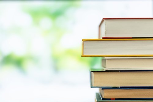 textbooks Photo of a stack of textbooks.