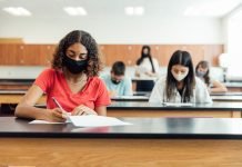Photo of students wearing face masks while doing work in a classroom.