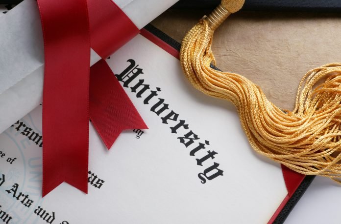 Gold tassel and rolled diploma with red ribbon Photo of a university diploma with a golf tassel and rolled diploma with red ribbon
