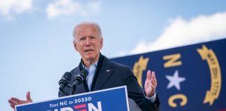 Photo of President-elect Joe Biden standing at a podium at a campaign rally