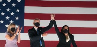 President Joe Biden, Vice President Kamala Harris, and First Lady Jill Biden celebrate their presidential win in front of an American flag.