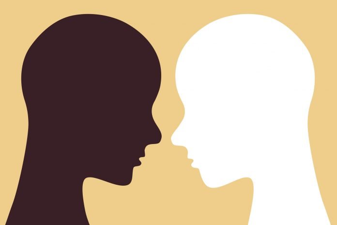 Face to face white and black colored human head Illustration of a Black person's head facing a White person's head.