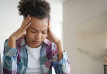 Black female college student resting her heads in her hands