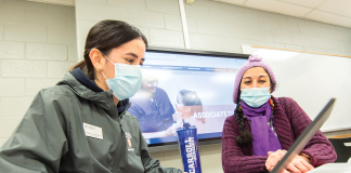Pamela Rubalcava (left), student support specialist for Carroll University’s ADN program, assists nursing student Veronica Aravena-Salgado.