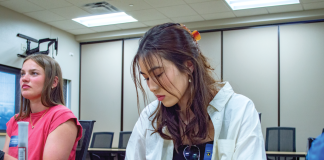 Students participate in a fingerprinting activity during a UW-Women in Criminal Justice Mentoring Program event at the Madison Police Department. (Photo courtesy of the UW-Women in Criminal Justice Mentoring Program)